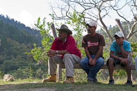 El Convento villagers listen during a discussion about the farm land.