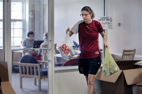 Kim Foley, assistant women's basketball coach, gathers items inside South College dormitory.
