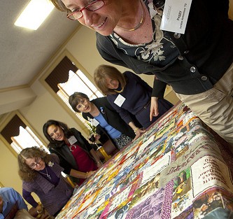 Attendees enjoy examining memories embedded in the 40th Anniversary of Coeducation Commemorative Quilt.