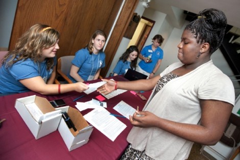 Valerie Acheampong '15, right, gets her room key inside Conway House.