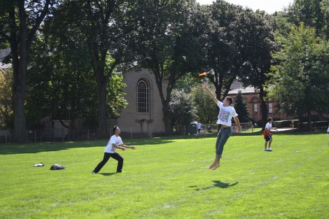 Students play frisbee on The Quad.