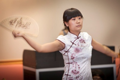 Qian Wang, visiting Fulbright teaching assistant of Chinese, performs a traditional Chinese fan dance.