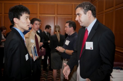 Tom Ahrens '02, right, of Turner Construction Company  talks with Daniel Kim '13, a civil engineering major.