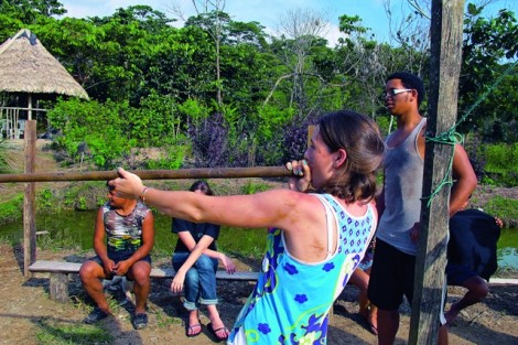 Morgan West ’13 practices her blowgun technique during an Alternative School Break trip with the Shuar people of Ecuador.