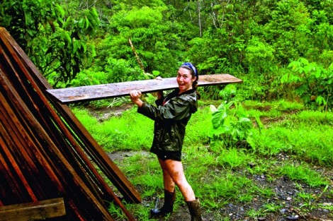 Camille Borland ’13 moves lumber meant to build a building for a botanical garden during an Alternative School Break trip to Ecuador. 