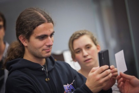 Daniel Robitzsk '15 reads a QR code on his cell phone.