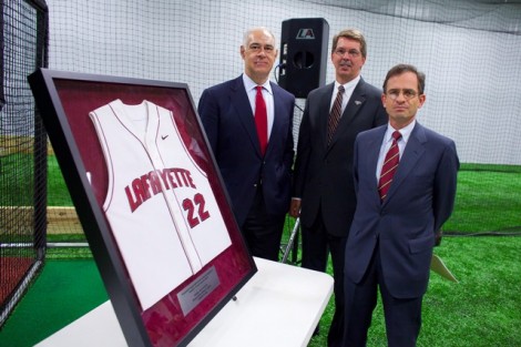 Don Morel '79 (L-R), Bruce McCutcheon, director of athletics, and President Daniel Weiss with Morel's baseball jersey 