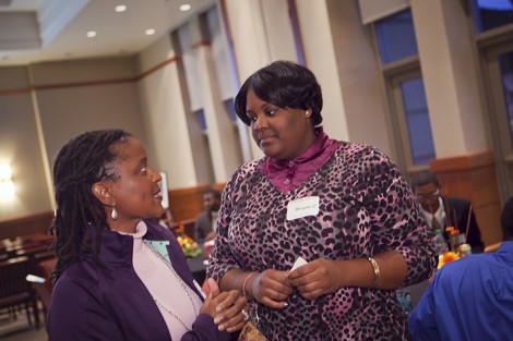 Dr. Cynthia Paige '83 (left) speaks with Breyon Brown '12.