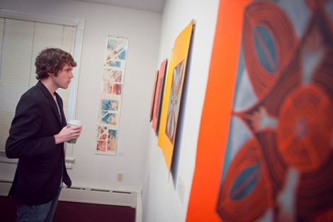 Matt Golman '13 looks at the artwork.