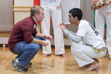 Tom Brinkerhoff '13, left, with members of the dance troupe Abada-Capoeira.