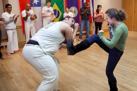 Annalaura Linder '14 tries out some moves with members of Abada-Capoeira.