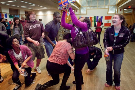 Students grab candy from the piñata.