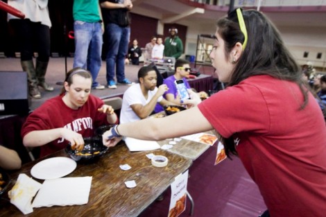 Rachel  Baer '14, right, cheers on Kerry Donohue '14  during the wing-eating competition.