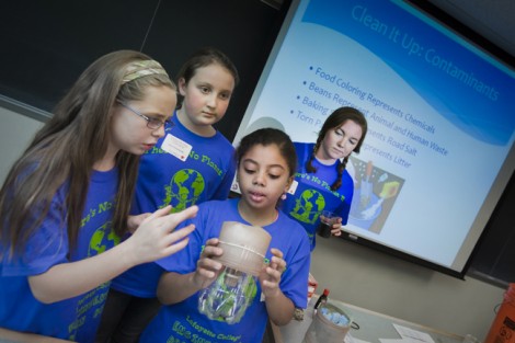 Jen White '14, right, watches as students check how well their filter works.