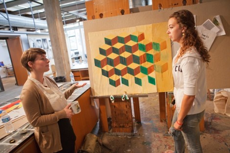 Allison Thompson '09, left, and Katie O'Neall '12 discuss one of O'Neall's pieces. 