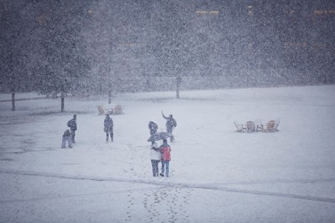 Students play in the snow out on the Quad.