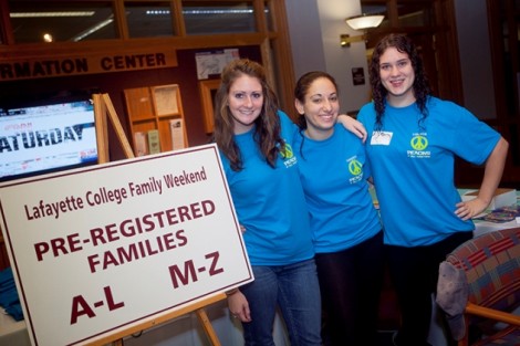 Rebecca Heslin '12, Jocelyn Bookman '14, and Hannah Grover '13 greet families at the registration table.