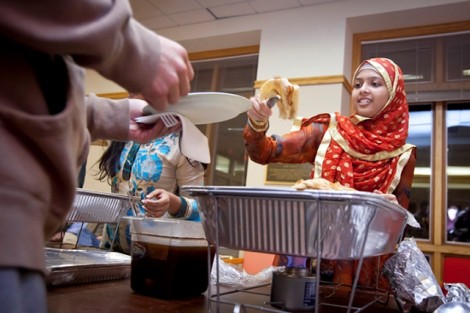 Thafhim Muna Siddiqua '13 serves traditional Muslim food.