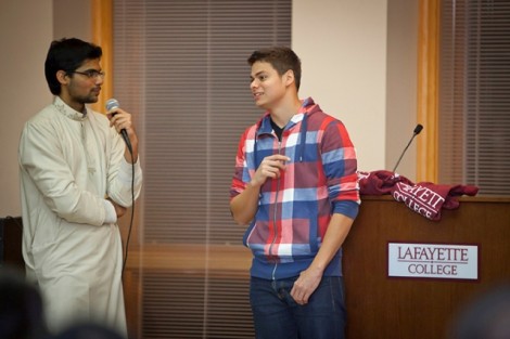 Hassaan Khan '13, left, asks Eddie Andujar '15 a question during a quiz portion of the event.