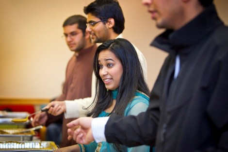 Shabhia Akter, '15, center, serves food during the Muslim Student Association's Eid-al-Adha dinner in the Marlo Room of the Farinon Center.