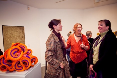 Curator Susan Huxley, center, talks with visitors to the exhibition.