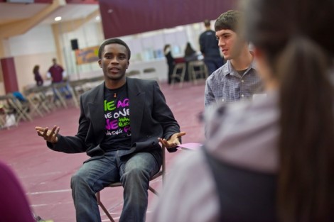 Chrispin Otondi '13 speaks with other students.