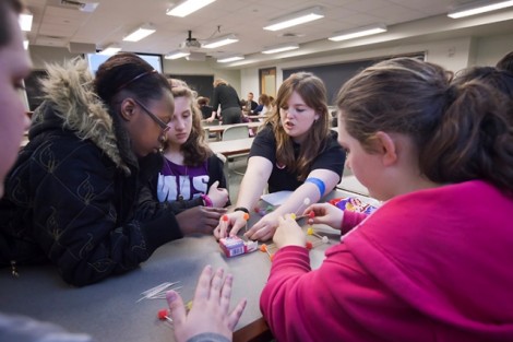 Emily McGonigle '15, center, helps students with their bridges. 