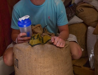 Stefano Valle '14 with a sack of cocoa beans ready for export
