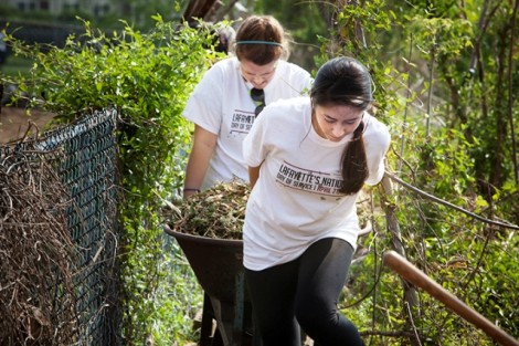 Libby Lucy '15 and Danielle Noonan '15, in front, take a load of mulch to the community garden behind the Easton Area Neighborhood Center.