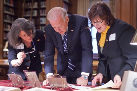 Leslie Muhlfelder, vice president for human resources and general counsel, left; Vice President Joe Biden; and Diane Shaw, director of special collections and College archivist, look over records about Biden's ancestors who attended Lafayette at Kirby Library.  