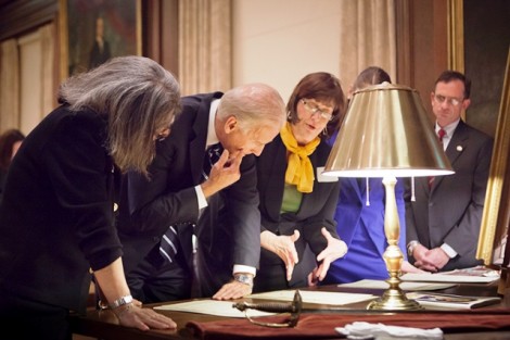 Leslie Muhlfelder, vice president for human resources and general counsel, left; Vice President Joe Biden; and Diane Shaw, director of special collections and College archivist, look over records about Biden's ancestors who attended Lafayette at Kirby Library.  
