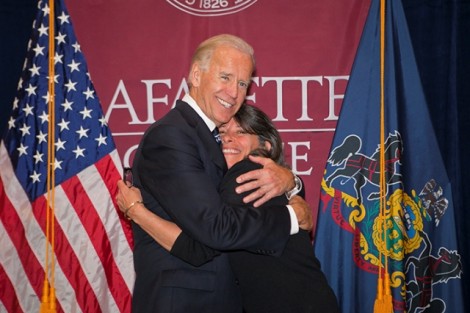 Vice President Joe Biden gives a hug to Leslie Muhlfelder, vice president for human resources and general counsel.