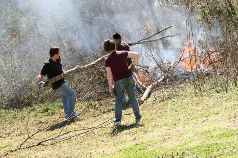 Tennessee- Mary Higgins (center) and Ryan Shroff '13 (right) join a University of South Florida student in burning brush.
