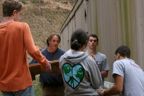 Tennessee- Dena Inqui '13 (center), Ryan Crumlish '13 (second from left), and Andrew Bahr '13 (far right) help carry a pallet as part of a project to rebuild a deck with reclaimed lumber.