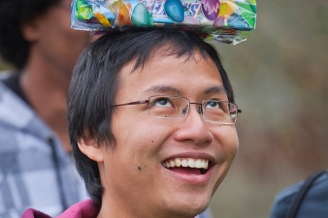 Tong Pham '13 balances a prize on his head.