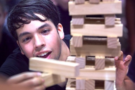 Daniel Guadalupe '16 carefully places a piece while playing Jenga.