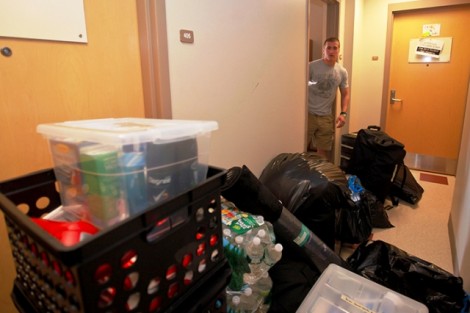 A student surveys all the items that need to go into his dorm room in South College