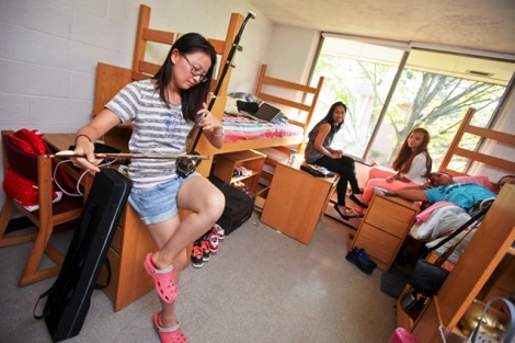 Dantong 'Jessica' Zhu '16 plays her ehru, a two-stringed acoustic instrument, in her Conway House room.