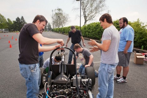 Students put the final touches on the car before a test drive at Metzger Field parking lot. 