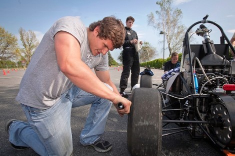 Shane Chalupa '12 examines the car after a few test laps. 