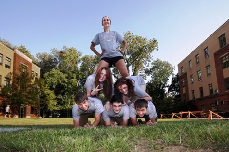 Students celebrate their victory by making a pyramid of people. In the bottom row, left to right, are Stephen Mazich '15, Sam Kapner '15, and Ian Crawley '15.  In the second row are Sarah Forsette '15, left, and Marybeth O'Connor '15. At the top is Heather Bauerle '14. 