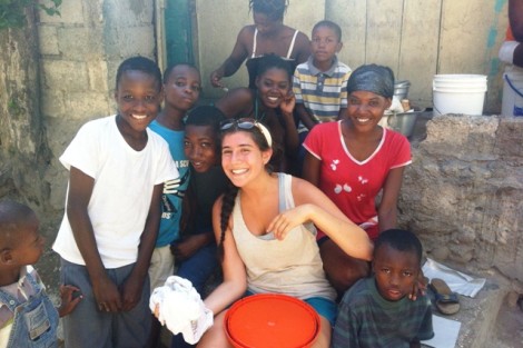Sarah Nusbaum '13 takes a break from work to visit with the community members.