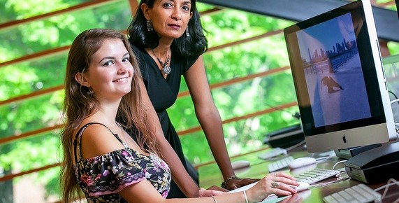 Daniela Filip ’15 and Professor Nandini Sikand edit film in Skillman Library.