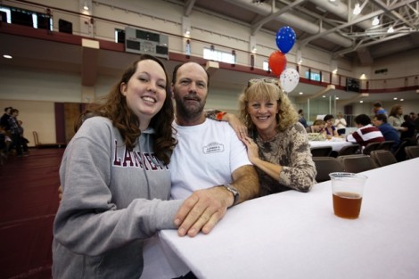 Elizabeth Gill '16, left, with her parents, Tom and Karen, at the Star-Spangled Family Tailgate in Kamine Gym. 