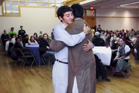 Evan Gooberman '13, left, president of Hillel Society, gets three hugs in rapid succession from Hassaan Khan ’13, president of the Muslim Students Association.