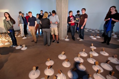 Students enjoy the reception for art professor Nestor Gil's Pan (Myopia) exhibition.