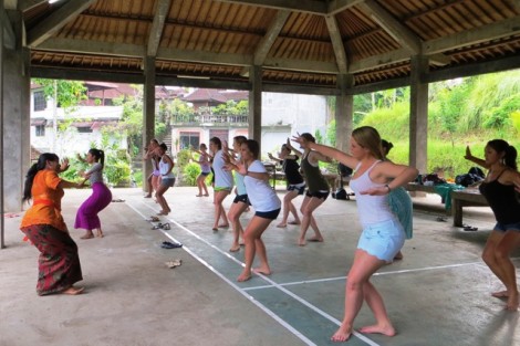The female students learn complex Balinese dance movements.