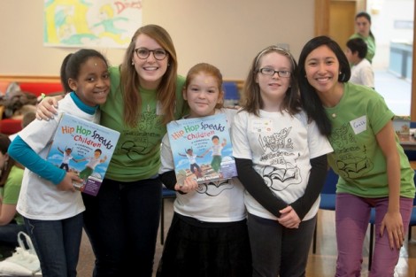 Elizabeth Lucy '15, left, and Gabbi Villanueva '15, right, pose with students during Literacy Day.