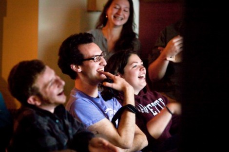 Brent Horowitz '14, center, and Stephanie Petersen '14 enjoy some stand-up comedy.