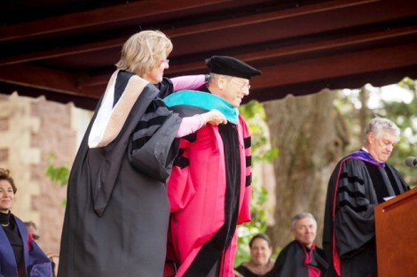 Nancy Kuenstner ’75 presents Robert Pastor ’69 with the hood emblematic of his honorary Doctor of Public Service degree.